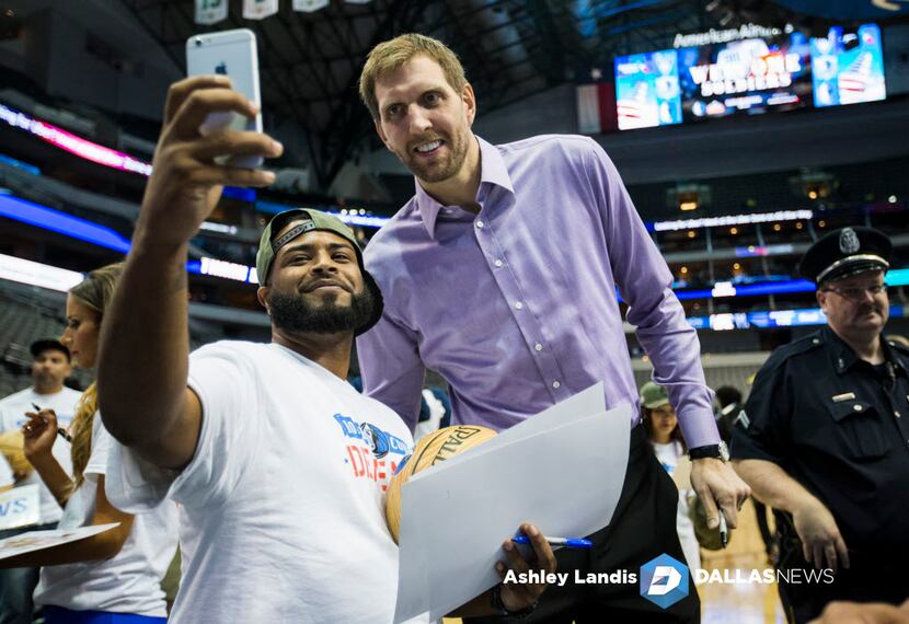 Dallas Mavericks forward Dirk Nowitzki (41) takes photos with wounded service members from...