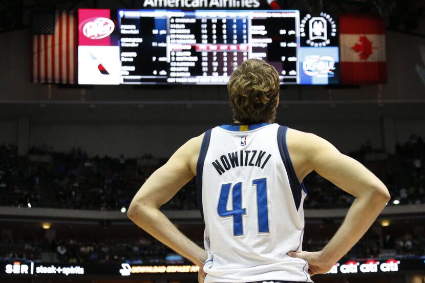 Dallas Mavericks forward Dirk Nowitzki (41) pauses to look at the scoreboard in the fourth...