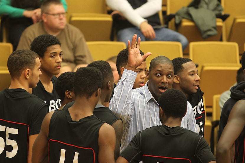 ABCD Basketball Academy Head Coach Glendon Alexander talks to his team during a timeout...