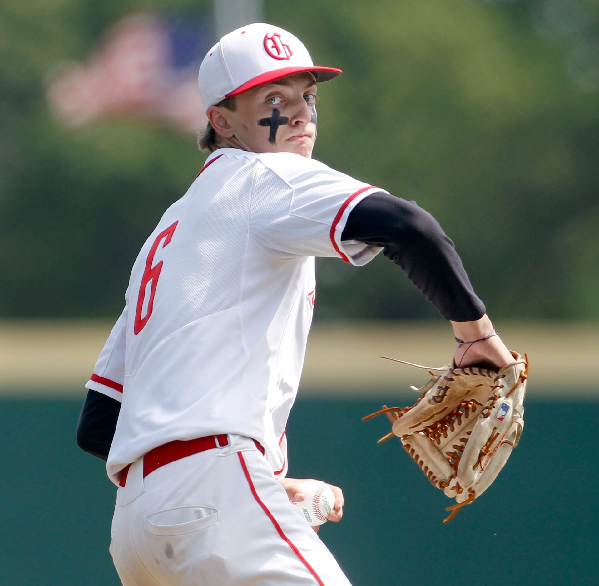 Grapevine pitcher Dasan Hill (6) prepares to deliver a pitch to a Midlothian Heritage batter...