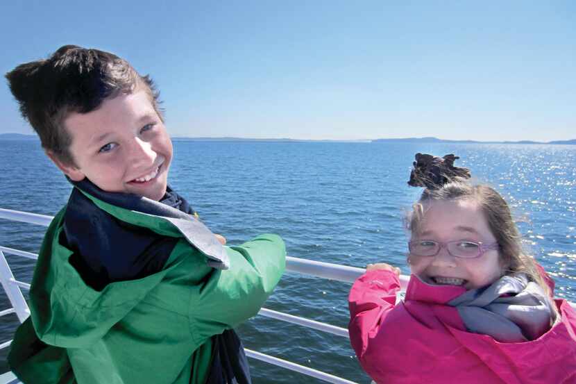 Cooper and Katie Damm hold on tight to the rails of a ferry in Nova Scotia on a Damm family...