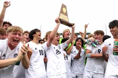 Flower Mound midfielder Colby Deleeuw (23) hoists the regional trophy as he celebrates with...