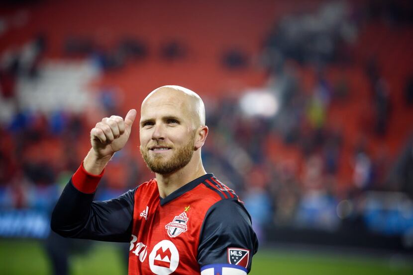 Toronto FC midfielder Michael Bradley gives a thumbs-up to the crowd following a victory...