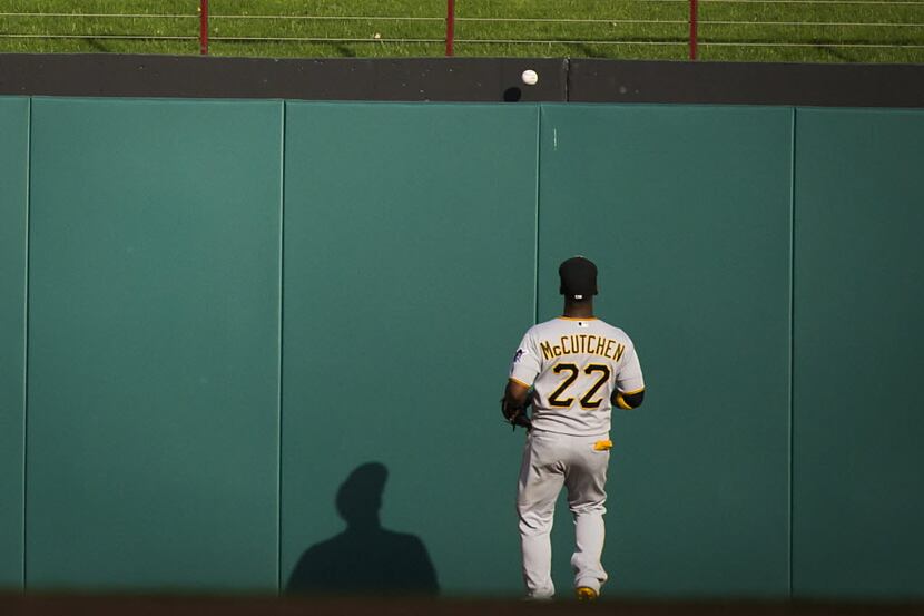 Pittsburgh Pirates center fielder Andrew McCutchen watches a a ball hit by Texas Rangers...