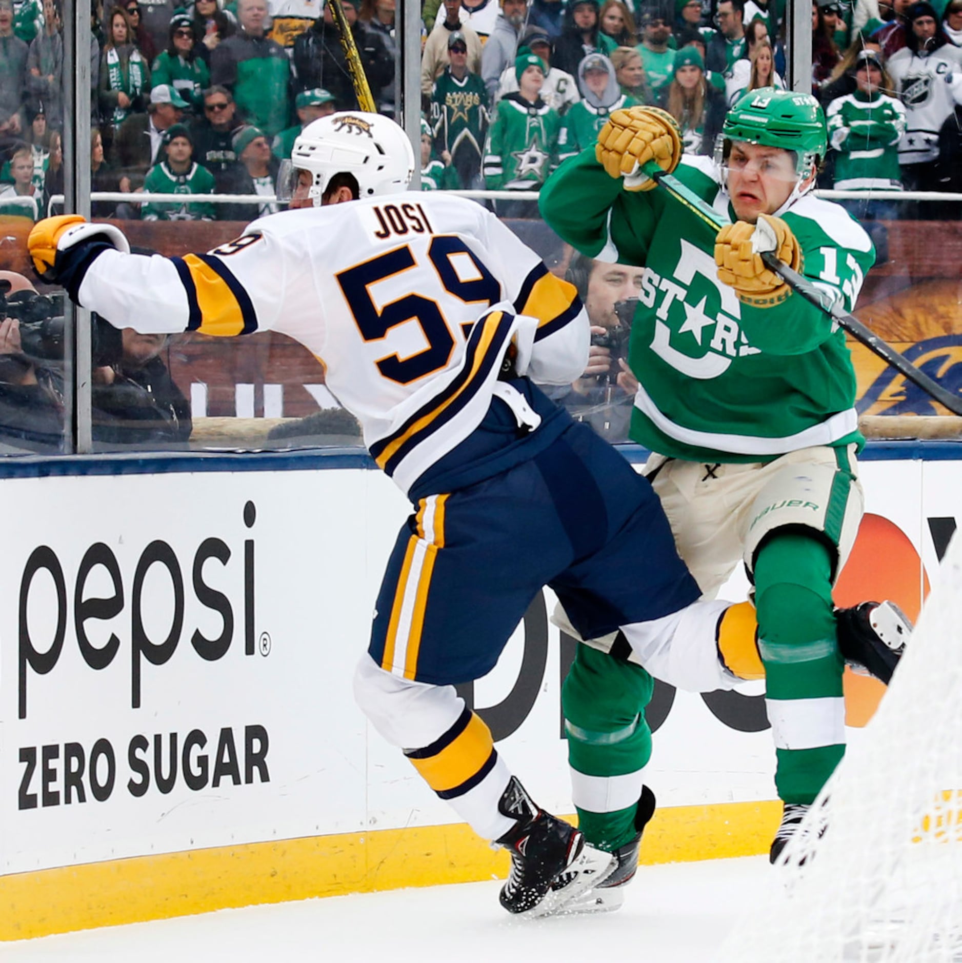 Dallas Stars center Mattias Janmark (13) gives a forearm check to Nashville Predators...