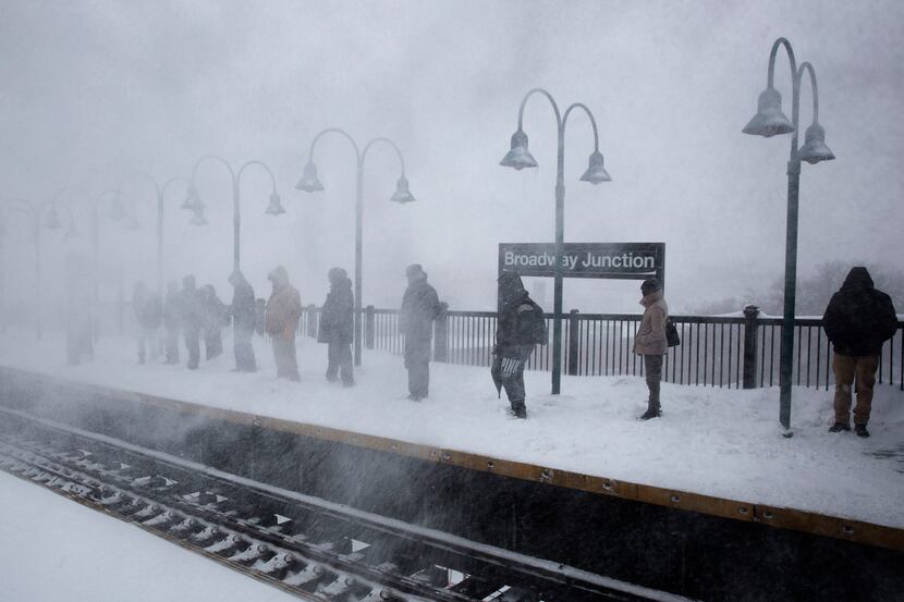  Passengers wait in heavy snows at the Broadway Junction subway station before the line was...