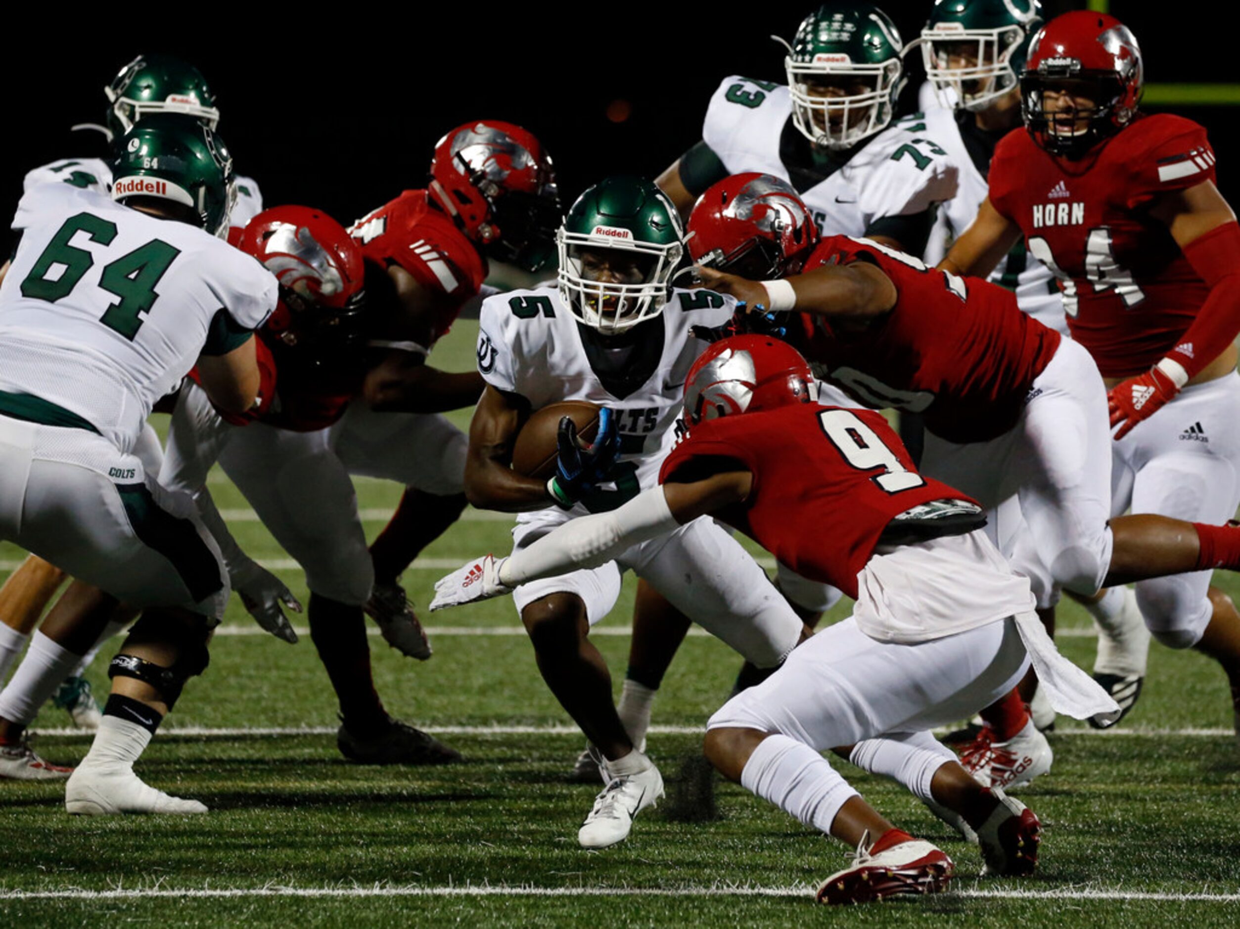 Arlington High Joel Hurray (5) is surrounded by Mesquite Horn defenders during the first...