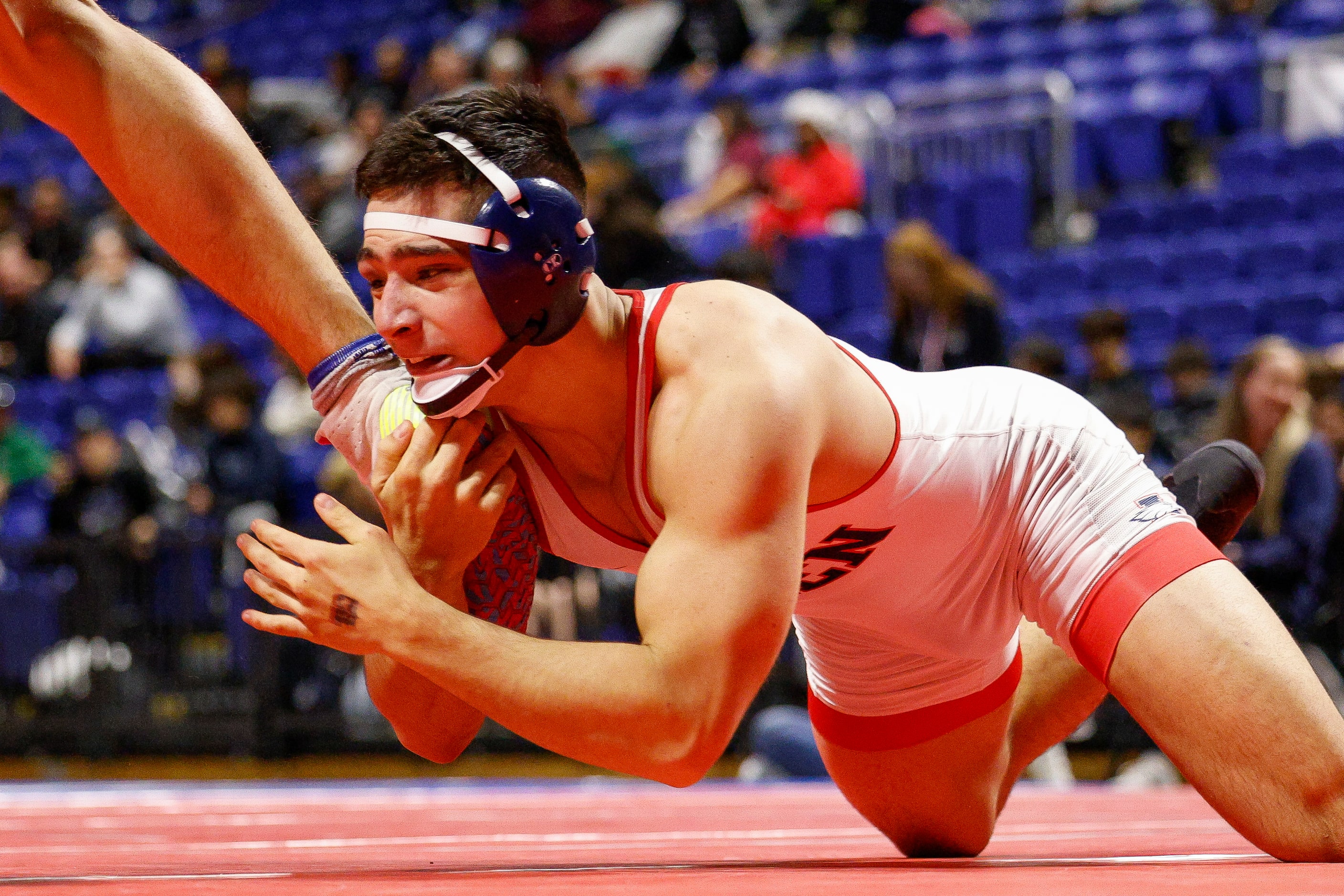 Ryan Nichols of Allen holds onto the ankle of Landon Marsh of New Braunfels during the...