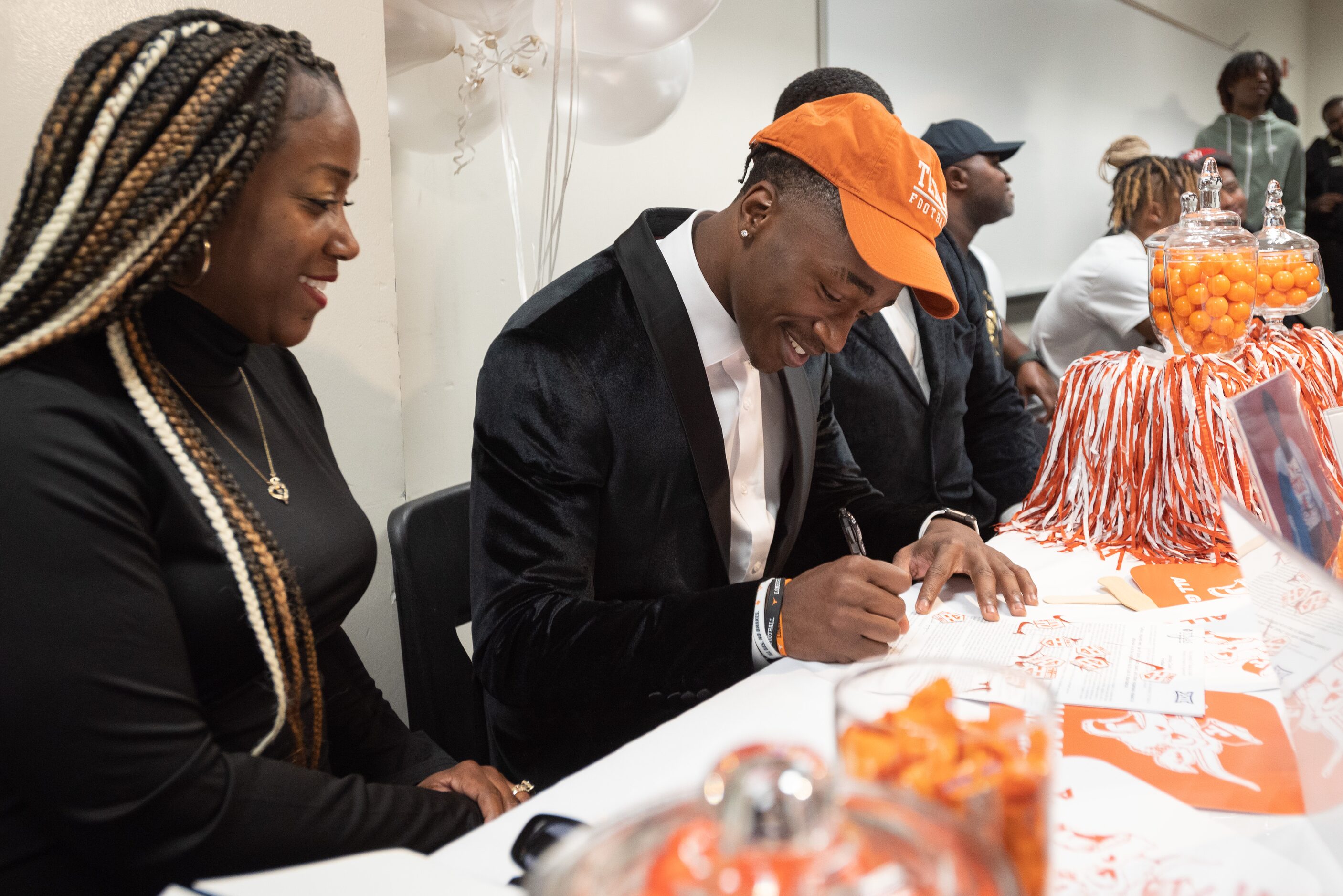 DeSoto high school football player Johntay Cook II signs his letter of intent to play...