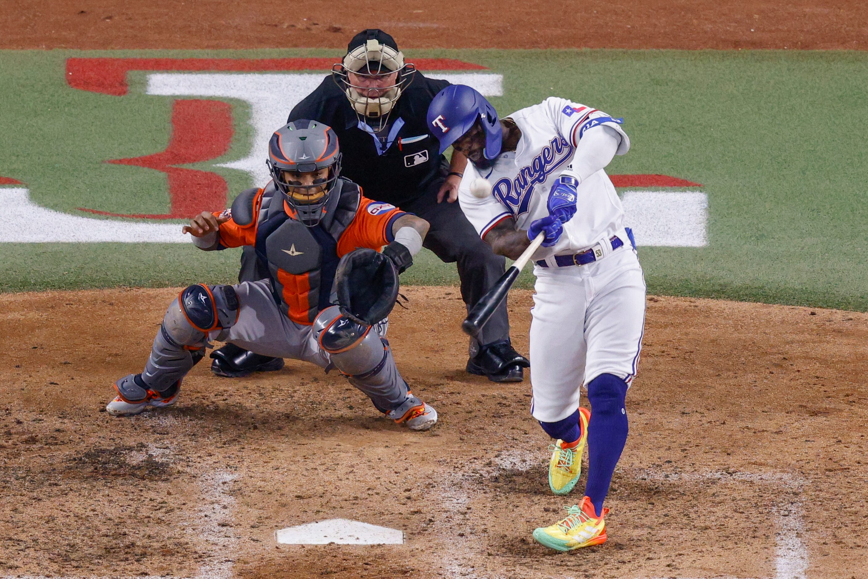 Texas Rangers right fielder Adolis Garcia (53) hits a three-run home run off of Houston...