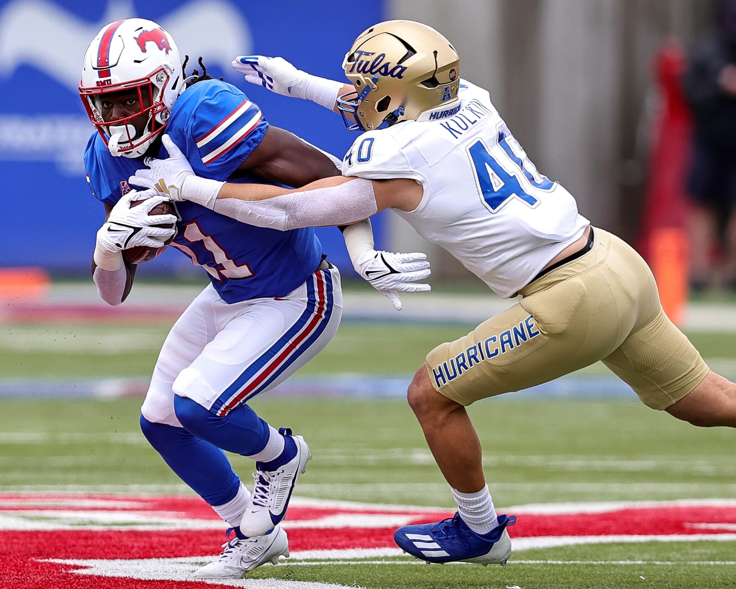 SMU running back LJ Johnson Jr (11) tries to elude a tackle from Tulsa linebacker Michael...