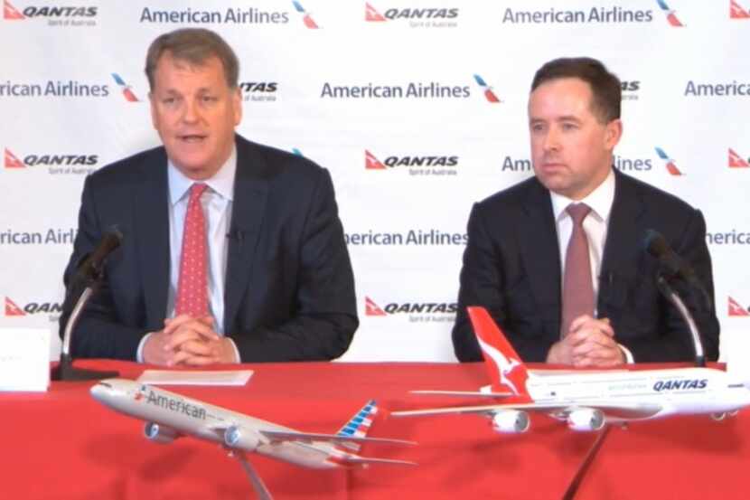  Doug Parker, left, speaks at Tuesday's press conference as Qantas CEO Alan Joyce awaits his...