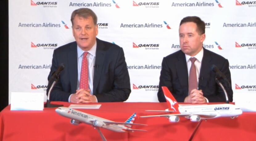  Doug Parker, left, speaks at Tuesday's press conference as Qantas CEO Alan Joyce awaits his...
