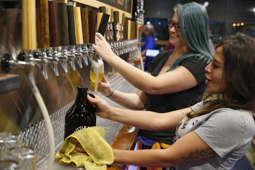 Beertenders, Hannah Riggert (left) and Alexis Massie serve beer at Little Elm Crafthouse in...