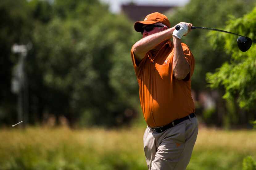 Former University of Texas football coach Mack Brown tees off at the ninth hole during the...