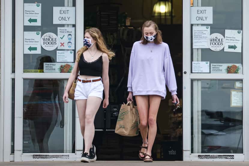 Emma Lloyd, 18, (left) and Harper Jones, 18, leave Whole Foods Market on Abrams Road in...