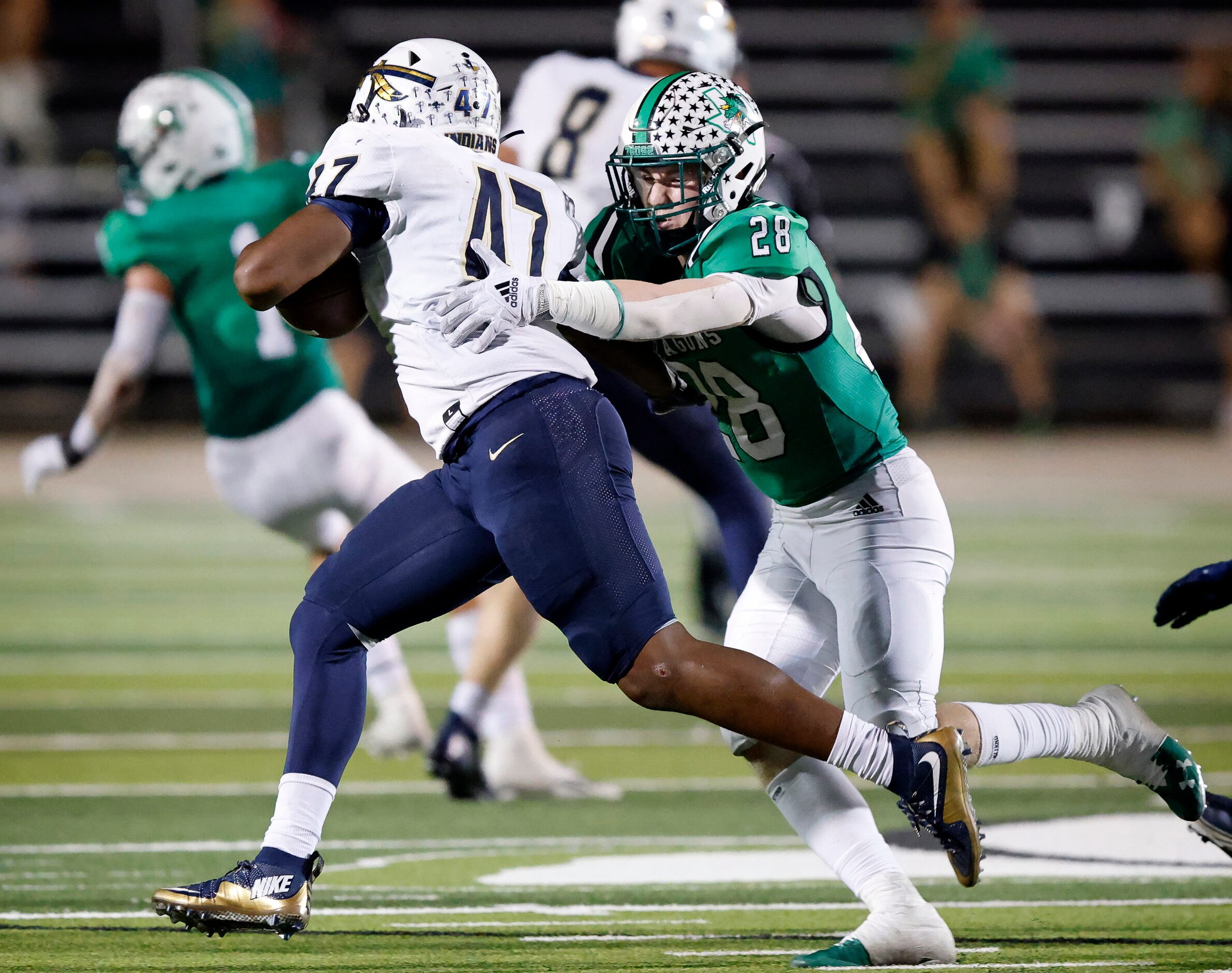 Southlake Carroll linebacker Aaron Scherp (28) tackles Keller running back Jayden Hart (47)...