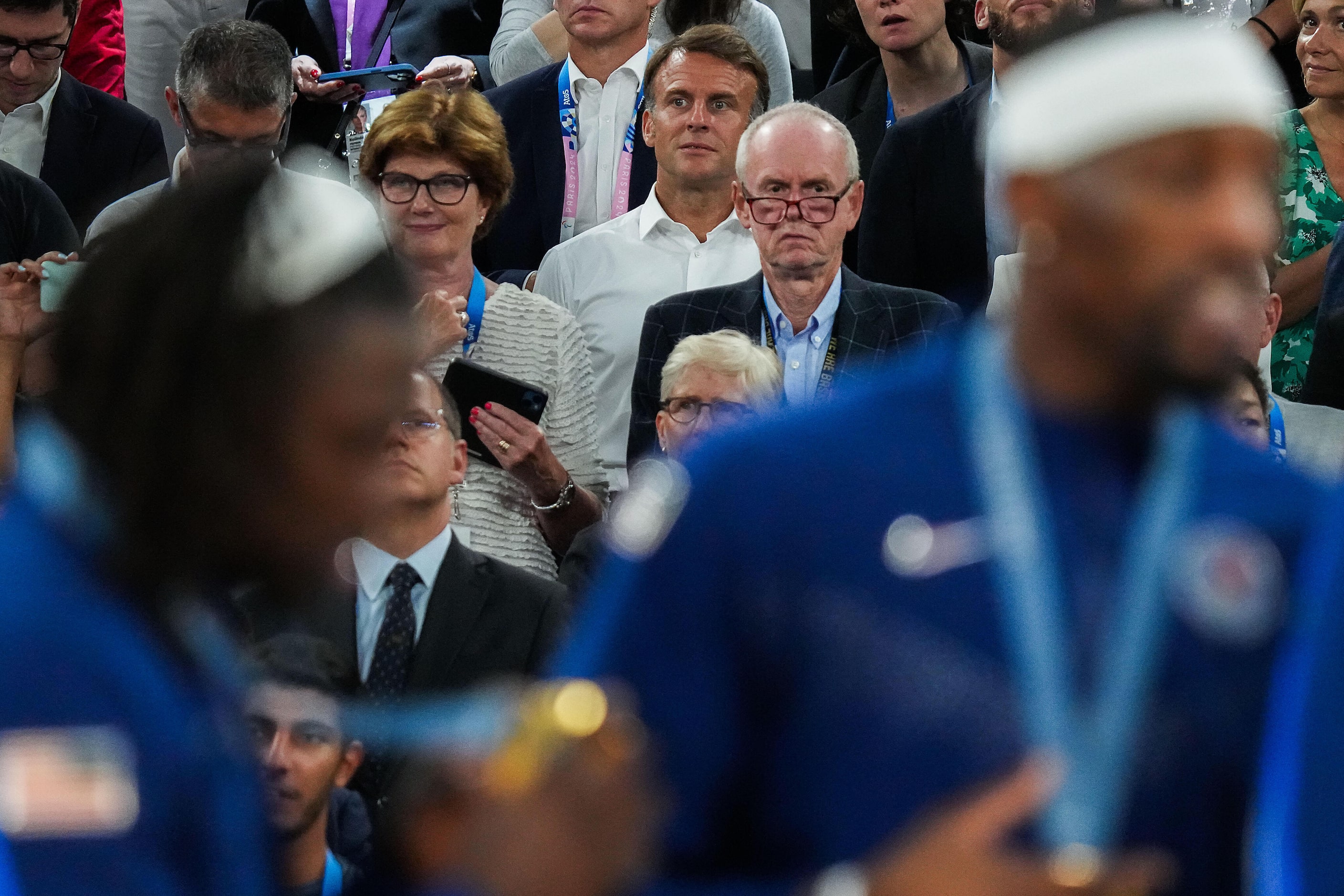 Emmanuel Macron, President of France, watches player from the United States receive gold...