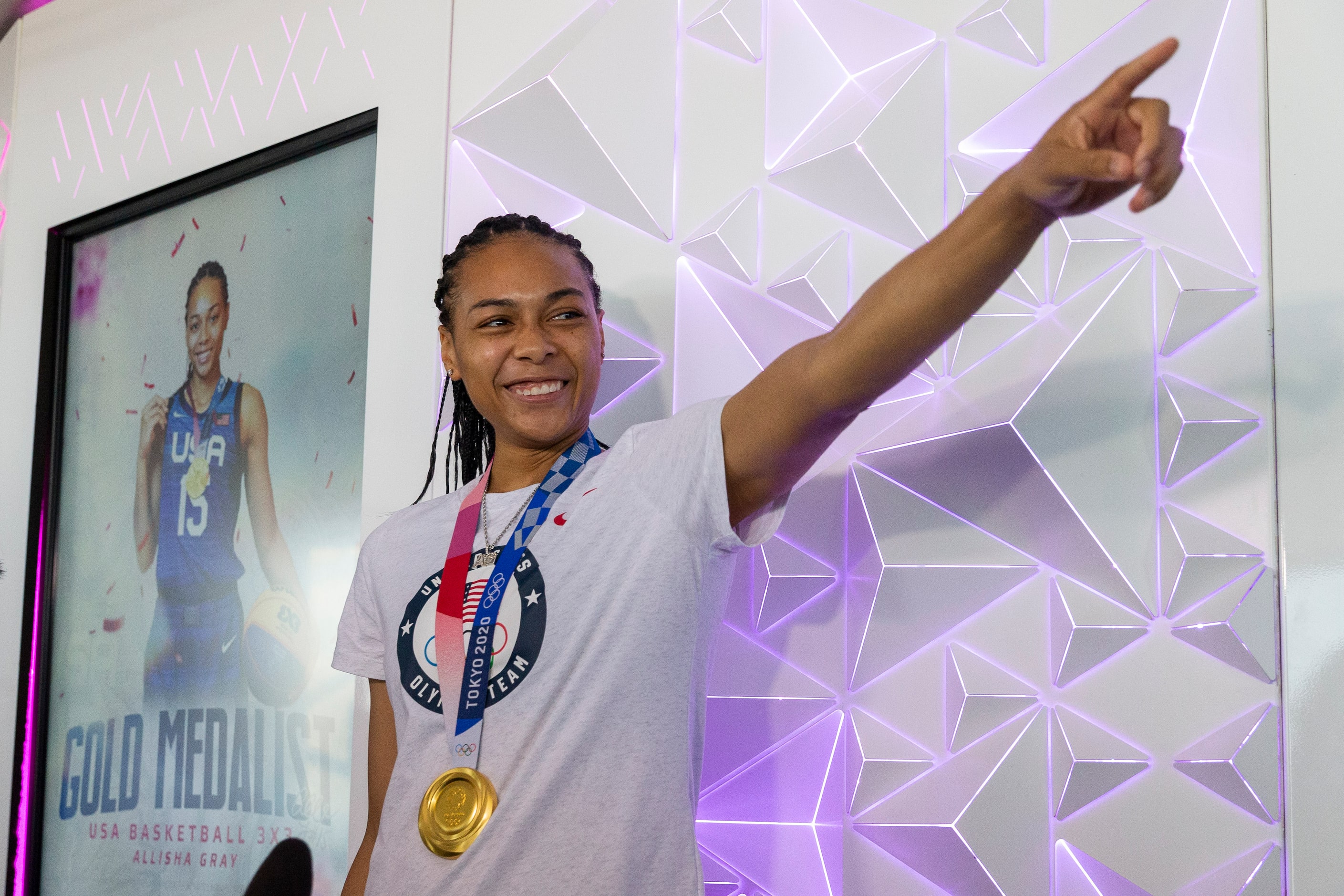 Allisha Gray, Olympic gold medalist and Dallas Wings guard, thanks her coaches during a...