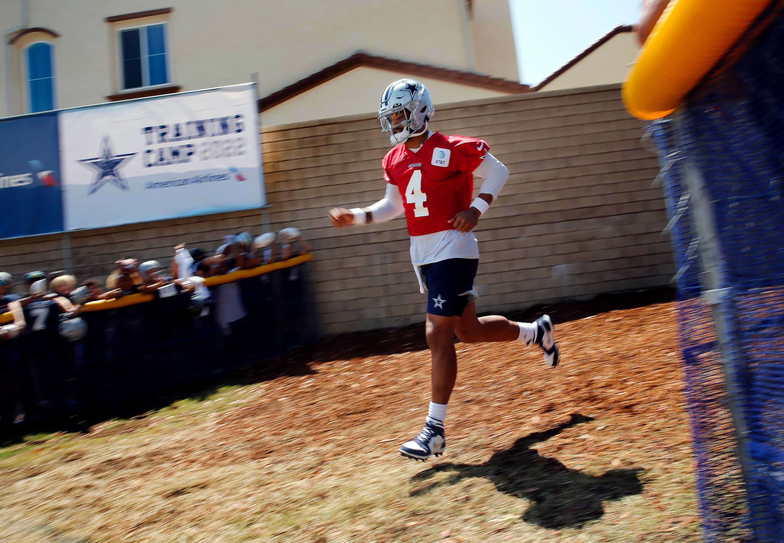 Dallas Cowboys quarterback Dak Prescott (4) jogs to the practice field for a Dallas Cowboys...