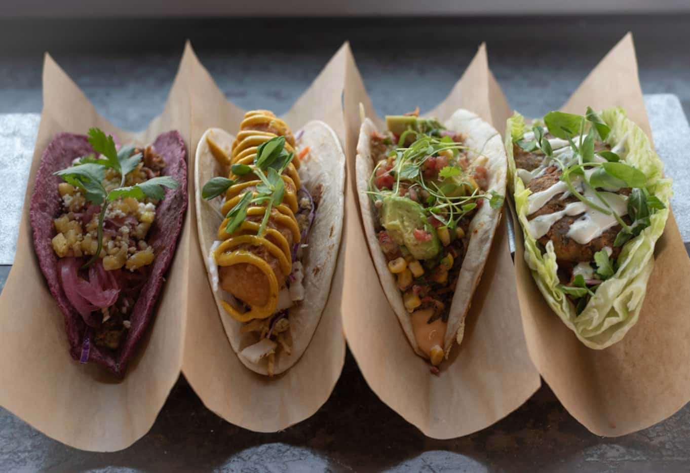 Velevat Taco sells a variety of creative tacos, including the Annatto shredded pork (left),...