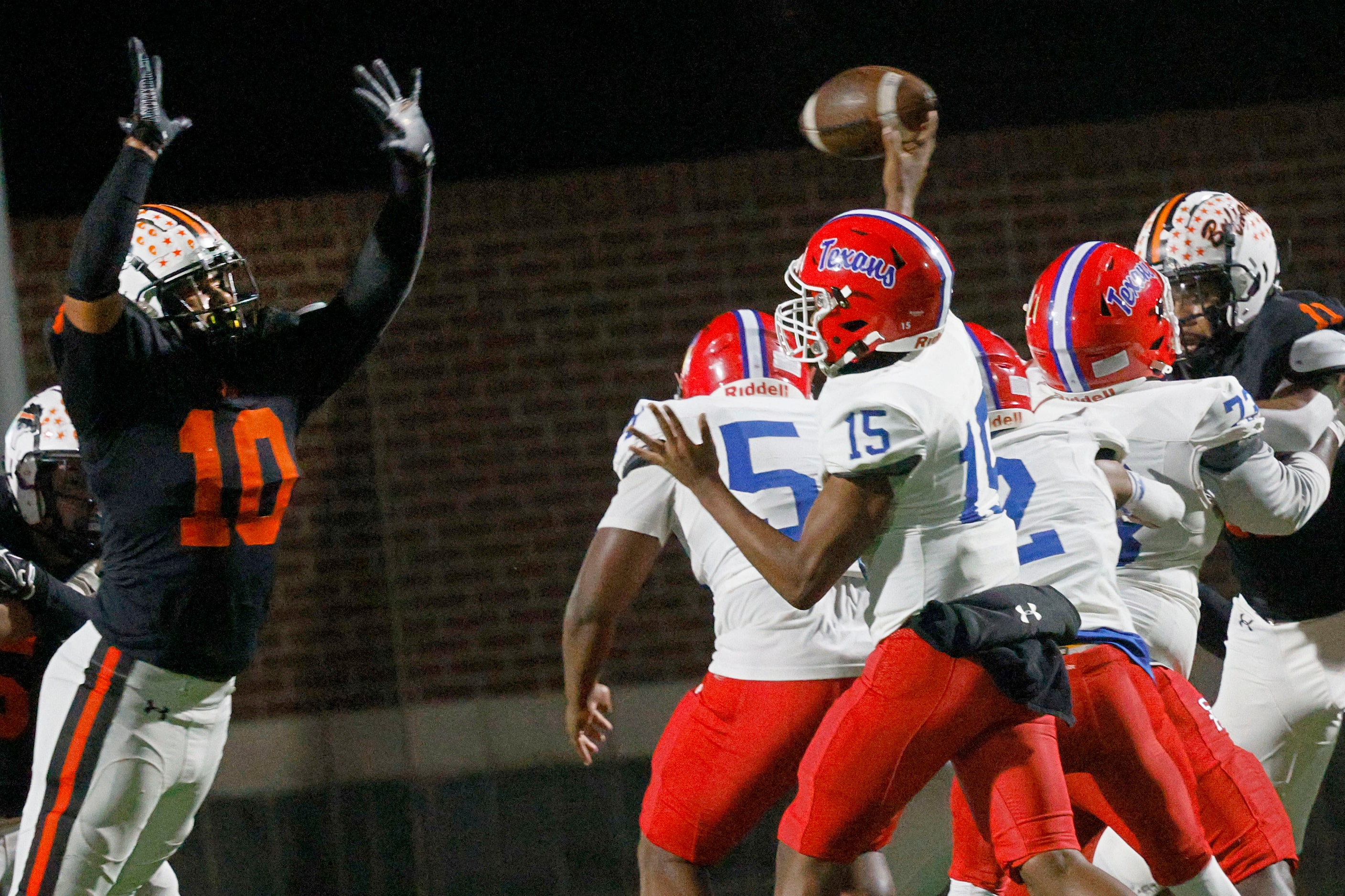 Sam Houston's quarterback Carmello Stokes (15) passes under pressure from Haltom's Jayden...