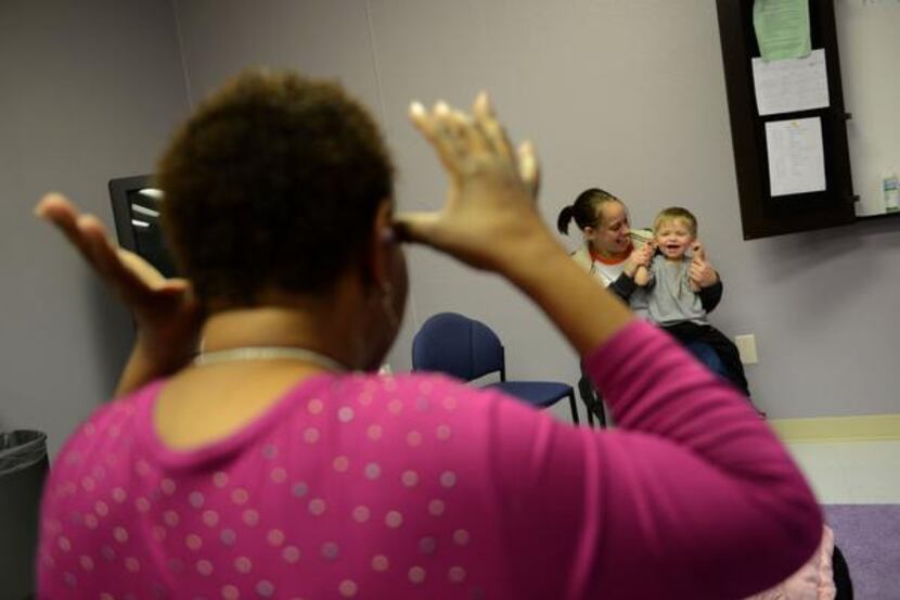 
Catherine Wright, a child specialist, sings a nursery rhyme to Sara Kendall’s son, Jaxon,...