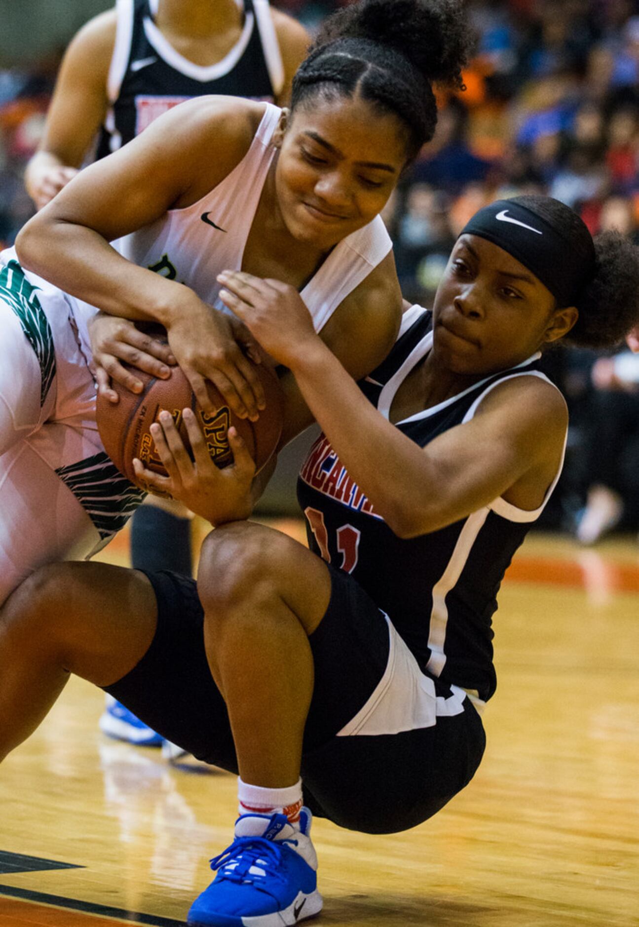 DeSoto's Kayla Glover (3) and Duncanville Tristen Taylor (11) fight for the ball during the...