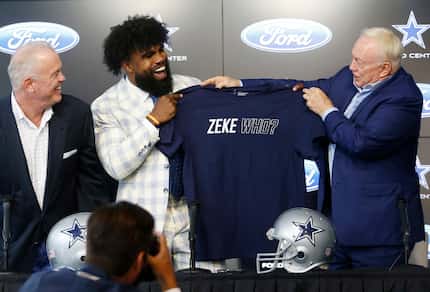 Dallas Cowboys owner Jerry Jones and running back Ezekiel Elliott hold up a shirt saying...