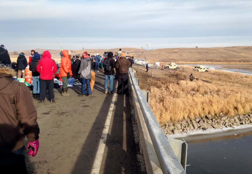 Protesters against the Dakota Access oil pipeline congregate Monday, Nov. 21, 2016, on a...