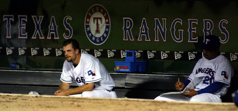Texas Rangers relief pitcher Jay Powell (39) sits on the bench with 1st base coach DeMarlo...
