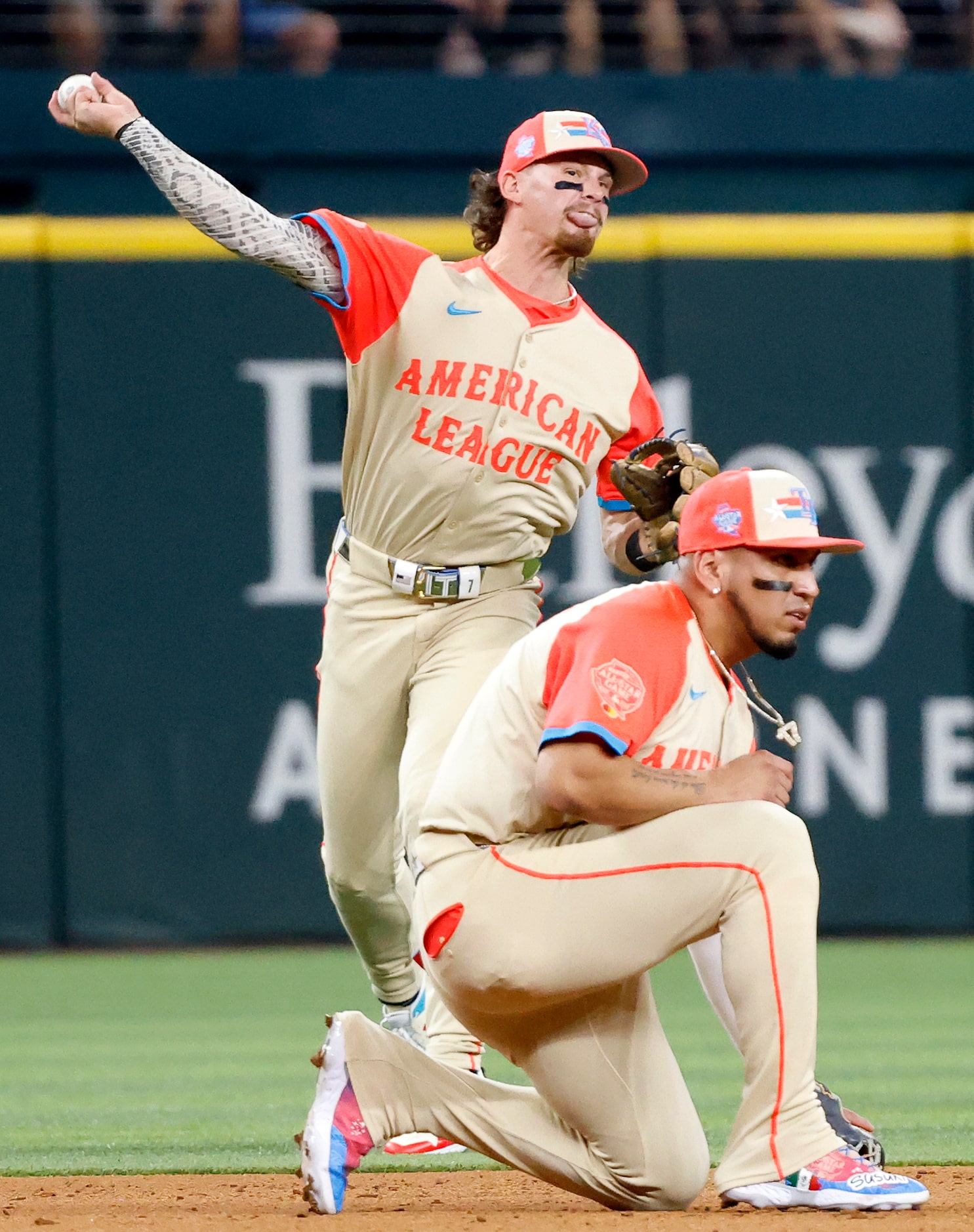 American League's Bobby Witt Jr., of the Kansas City Royals, fields a ball and throws out...