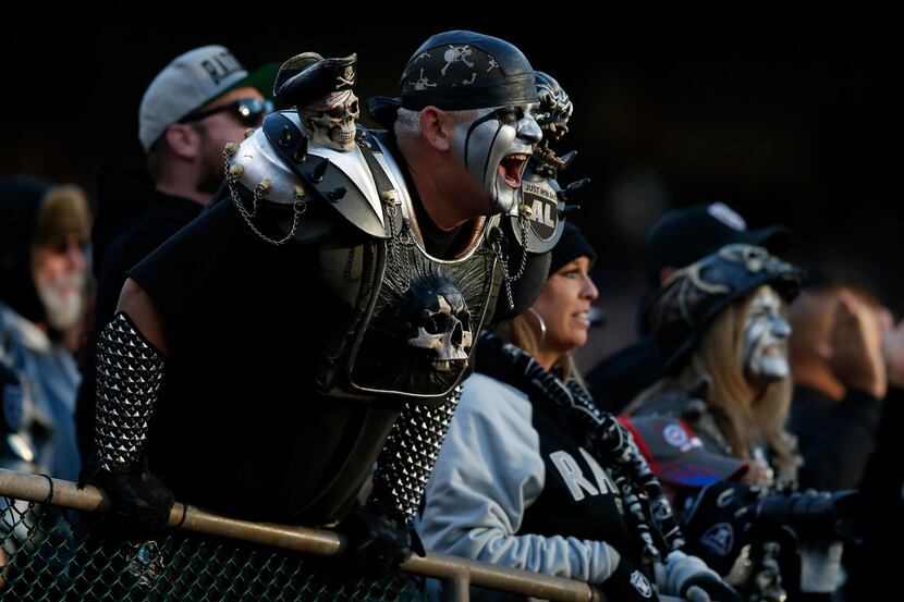 OAKLAND, CA - DECEMBER 03:  A Oakland Raiders fan cheers in the stands during their NFL game...
