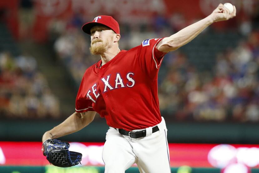 Texas Rangers relief pitcher Jake Diekman throws a pitch against Oakland Athletics during...