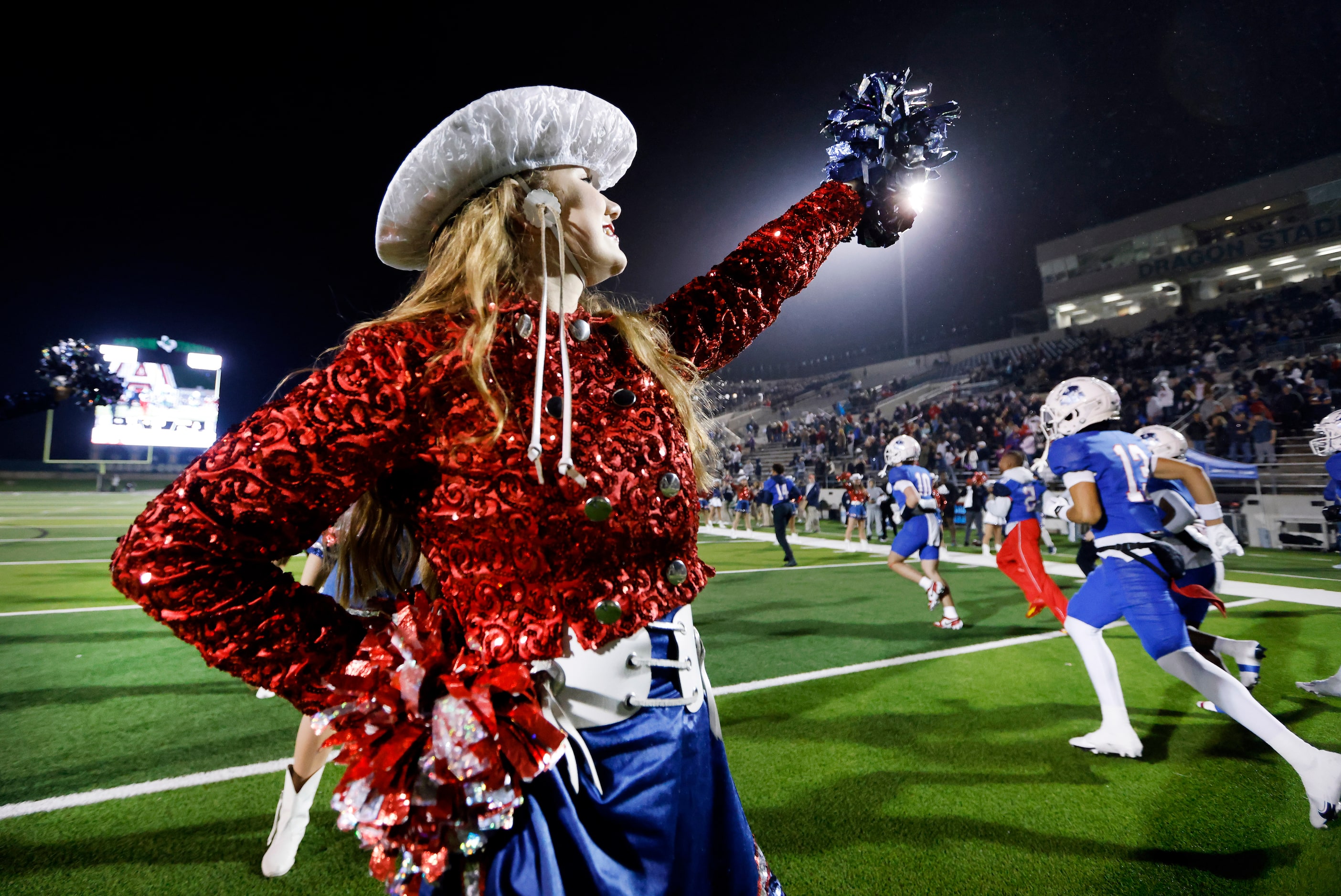 Emmajane Nelson, a member of the Allen High School's Tallenettes shakes her moms as the...