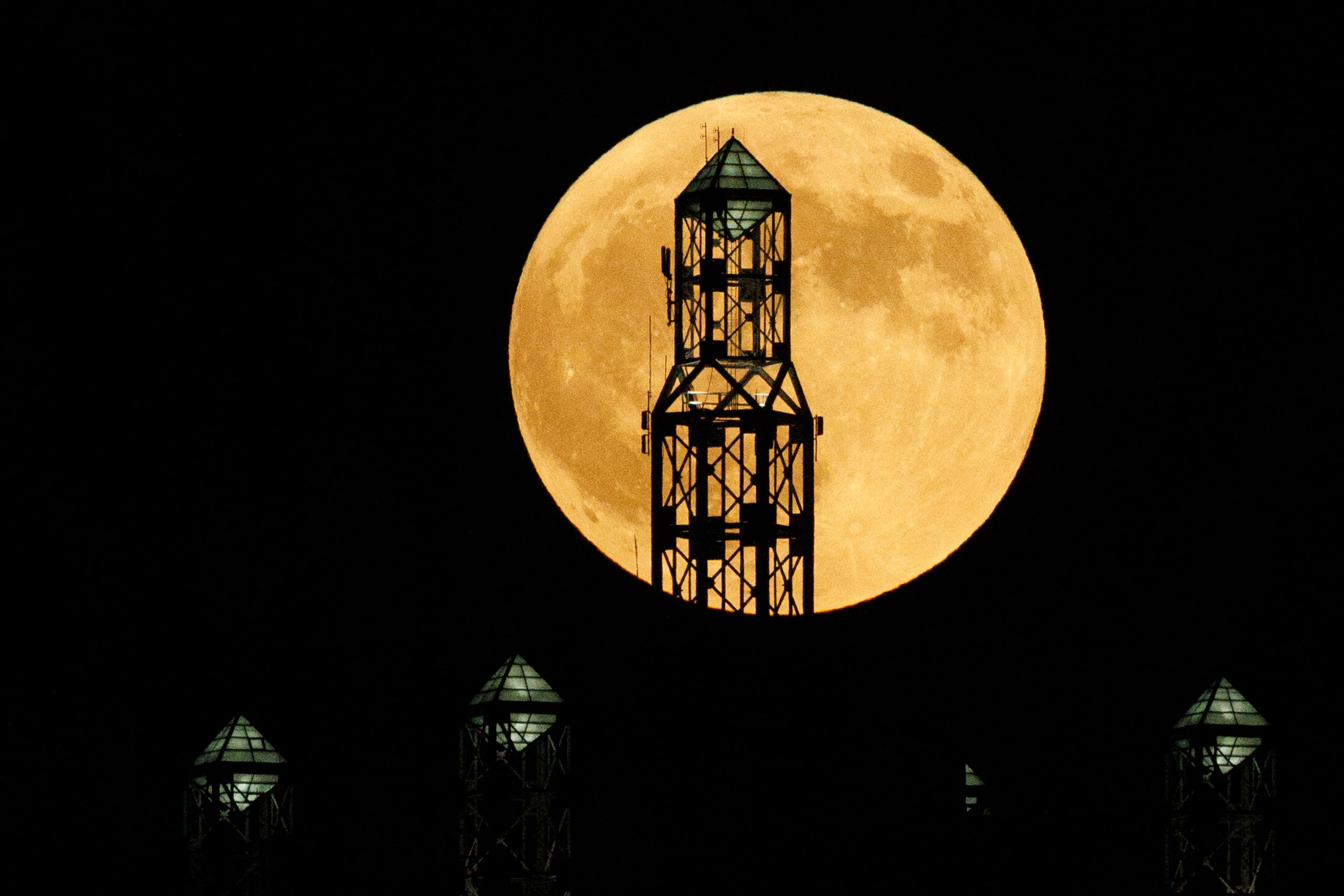 A partial lunar eclipse and supermoon is seen over Renaissance Tower in downtown Dallas,...