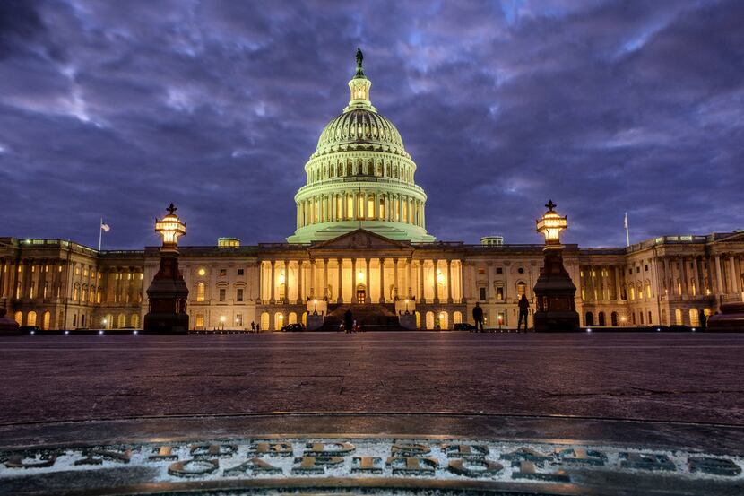 Lights shine at the U.S. Capitol Building as night falls in Washington on Sunday.