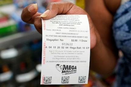 Stephanie Talton, of Des Moines, Iowa, holds her Mega Millions lottery ticket on Monday,...