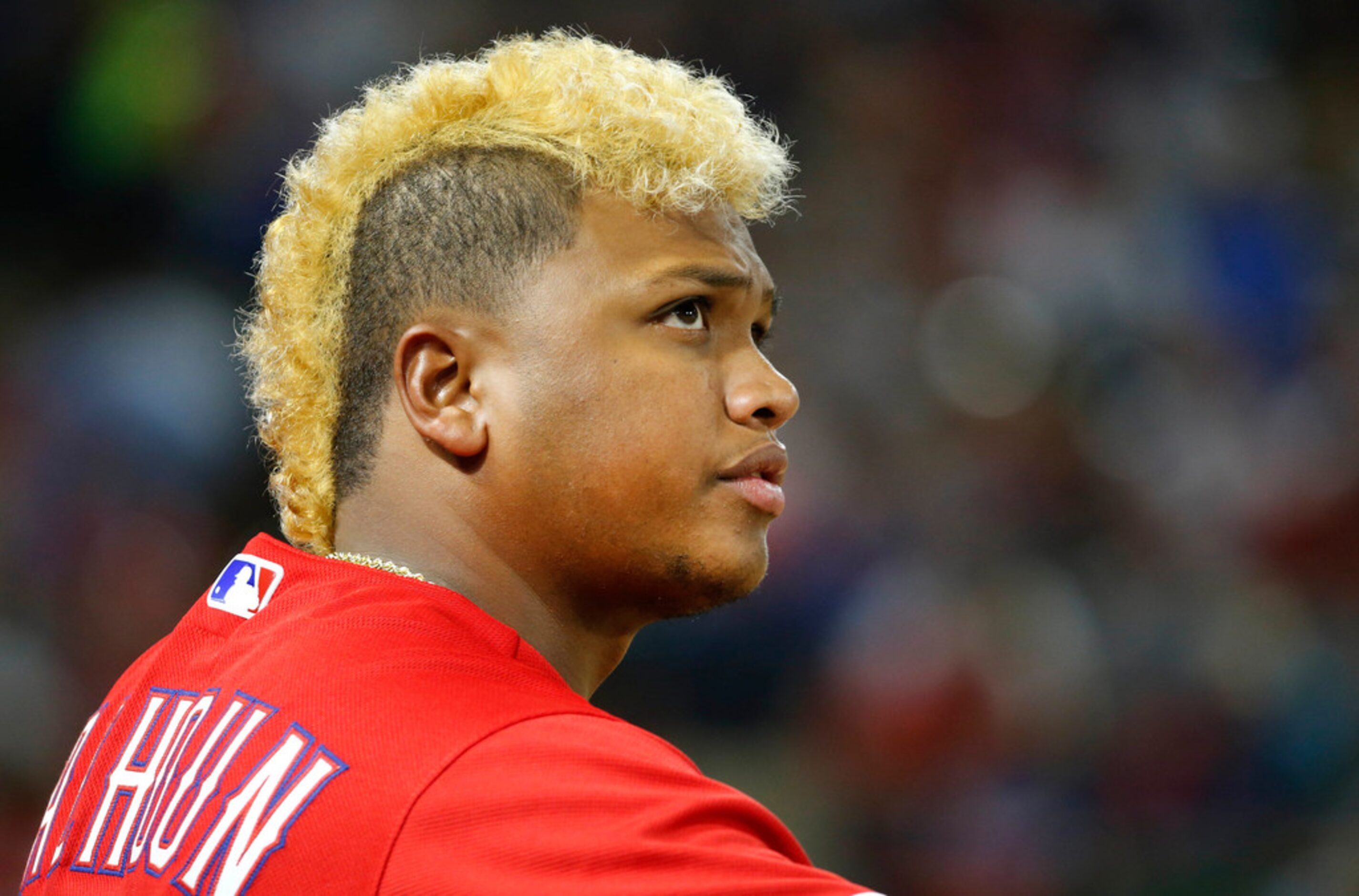 Texas Rangers designated hitter Willie Calhoun (5) waits for an at bat in the dugout in the...