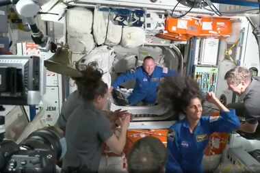 NASA astronauts Butch Wilmore and Suni Williams are greeted by the crew of the International...