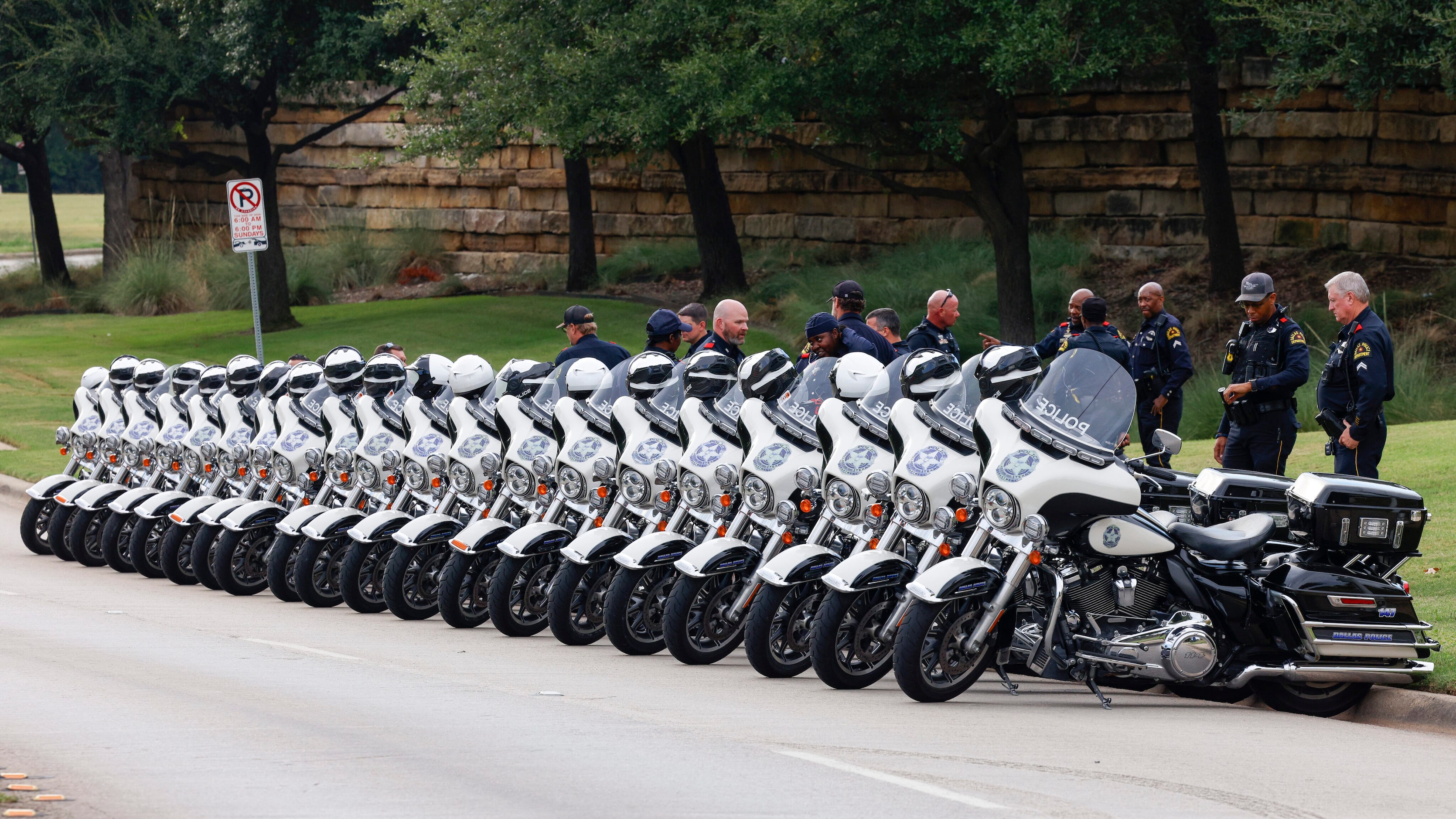 Members of the Dallas police motorcycle unit line the street during a public visitation for...