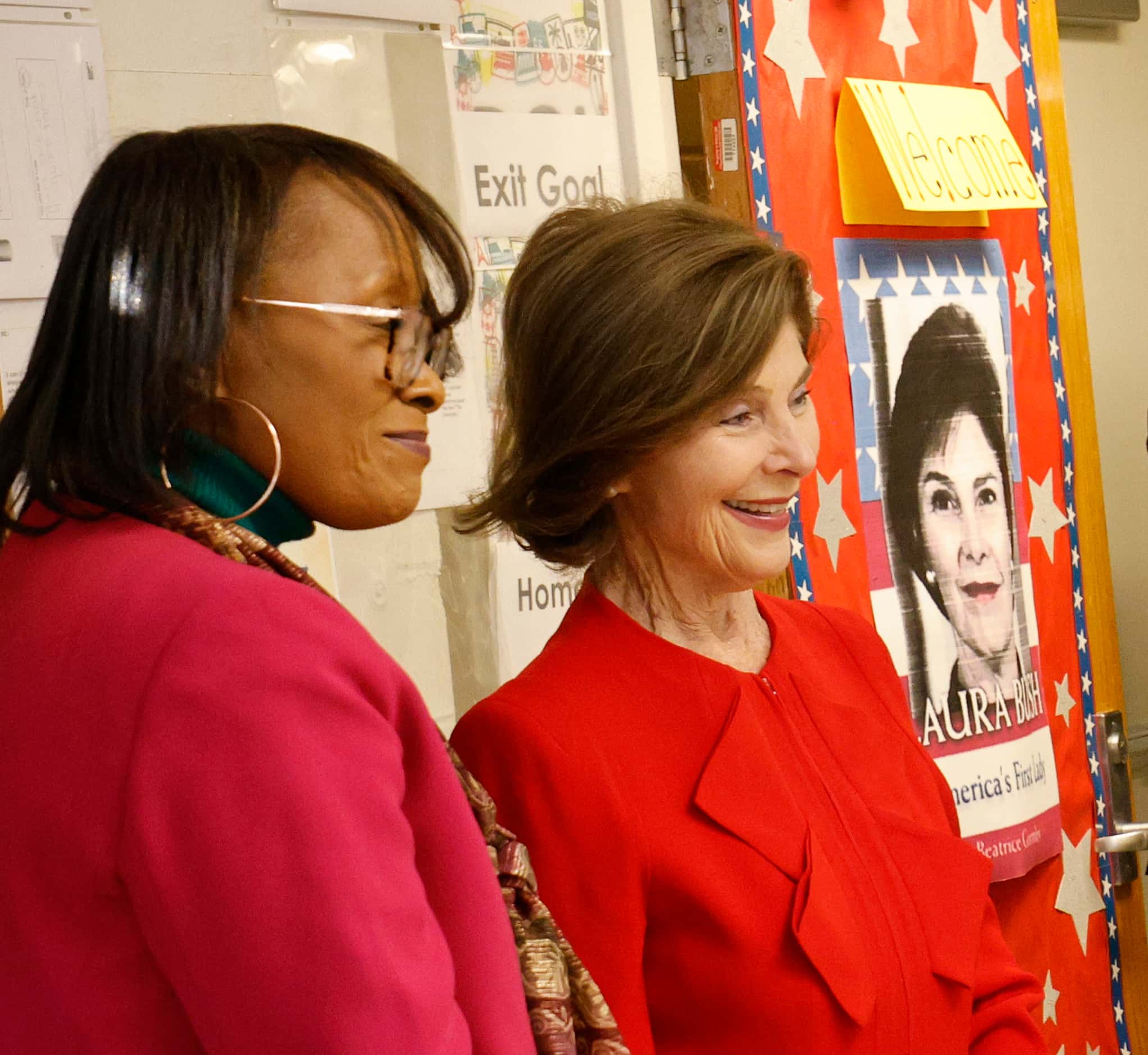 Jacqueline Wallace, a first grade teacher, left, greets former first lady Laura Bush, when...