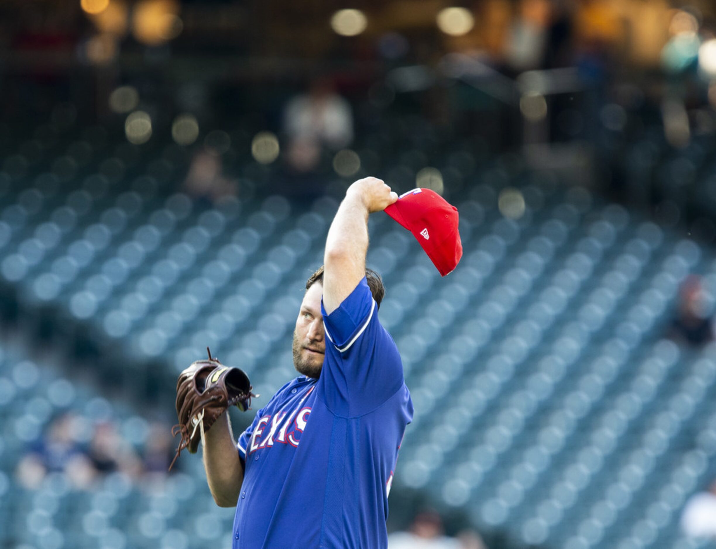 SEATTLE, WA - MAY 27:  Lance Lynn #35 of the Texas Rangers wipes his forehead after allowing...