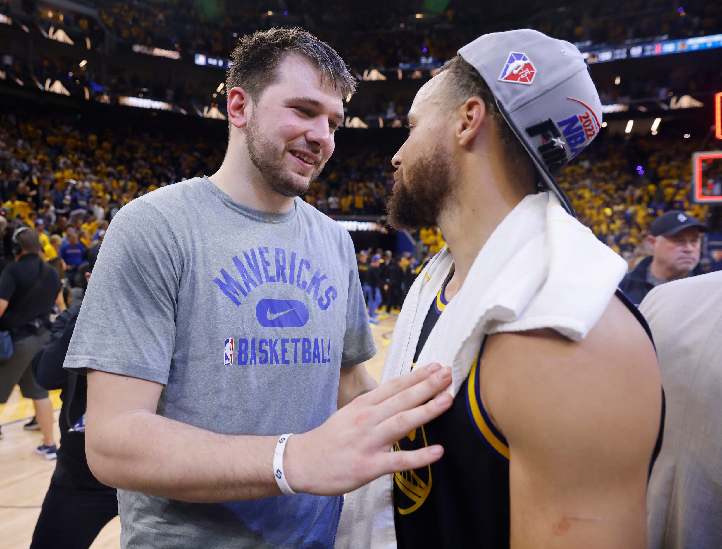 Dallas Mavericks guard Luka Doncic (center) congratulates Golden State Warriors guard...