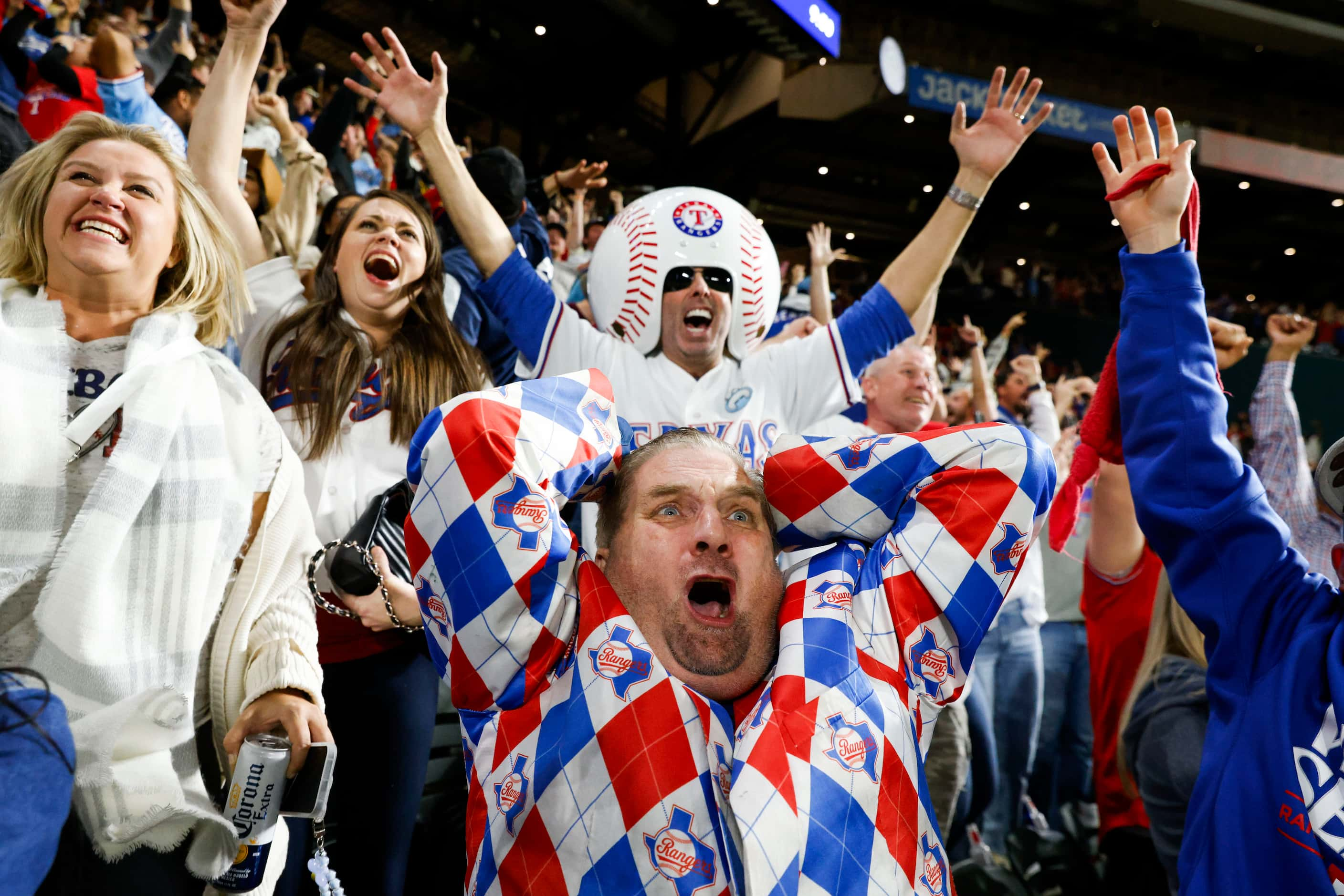 Texas Rangers fan from 1972, Terry Cox, (center) from Tyler, TX, including other, cheer...