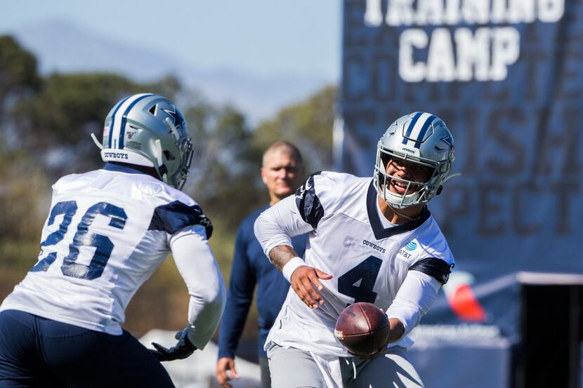 Dallas Cowboys quarterback Dak Prescott (4) hands off the ball to running back Darius...
