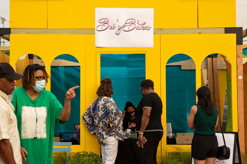 Bri Taylor of Bri's Bakes (center) spoke to customers at the launching of the MLK Food Park...