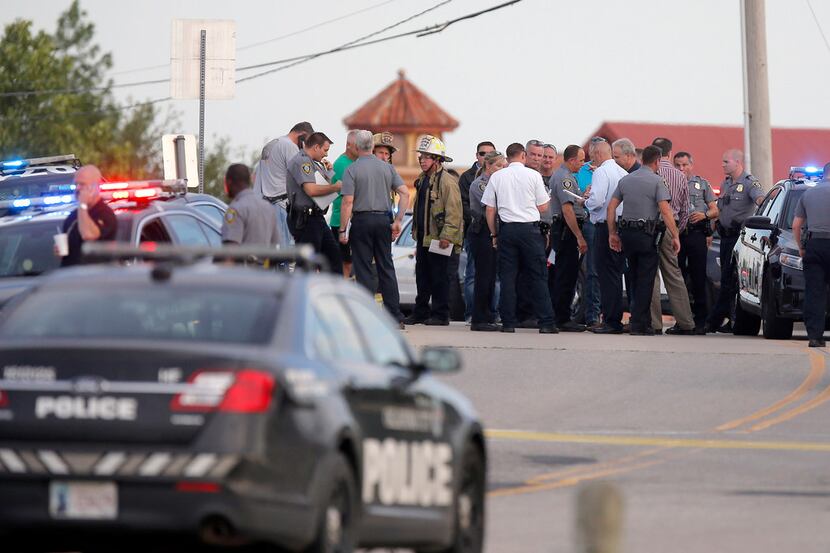 Police and emergency personnel surround the scene of a shooting at Lake Hefner in Oklahoma...