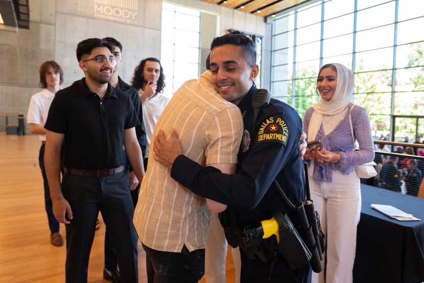 Police Officer Muhammad Rizvi is congratulated by friend Paul Rolon after Officer Rizvi...