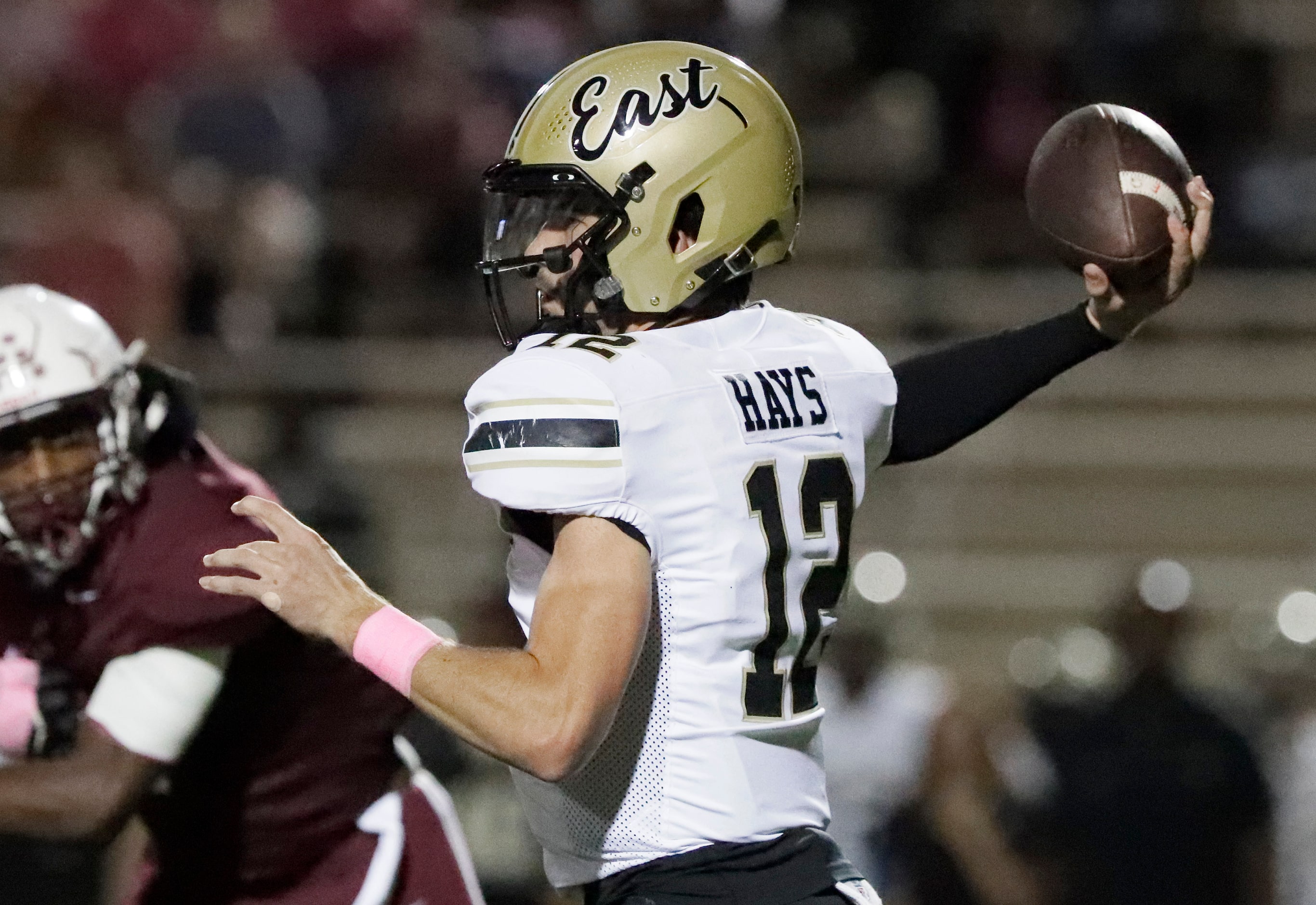 Plano East High School quarterback Jackson Hays (12) throws a pass during the first half as...